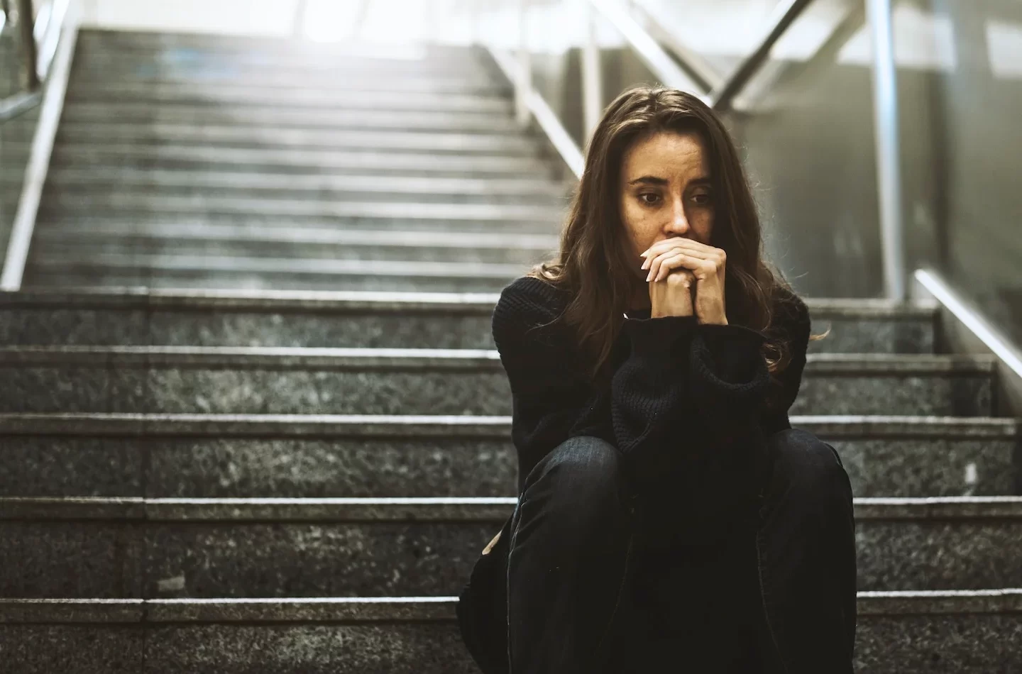 woman-sitting-look-worried-stairway